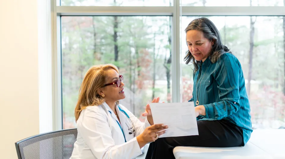 Dr. Leyda Delgado has a conversation with a patient during a primary care visit